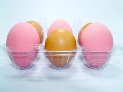 pink and yellow eggs on a stand