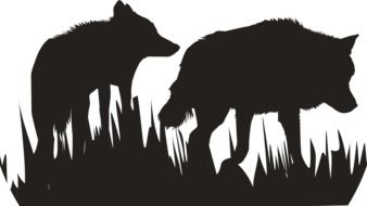 black silhouettes of wolves in the grass