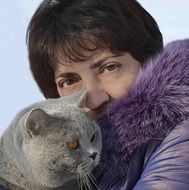 portrait of a woman with british blue cat