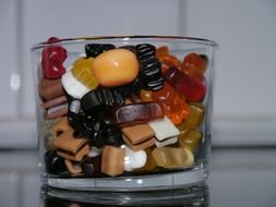 multi-colored candies in a glass cup