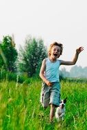happy boy running with a dog