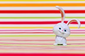angry white rabbit on a background of colored bands