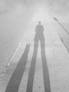 Black and White photo of Human and Dog shadows