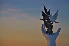 pigeons on hand sculpture