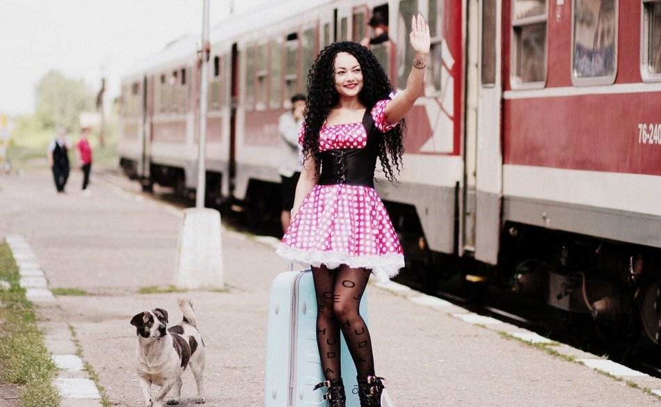 girl in pink dress on the train station