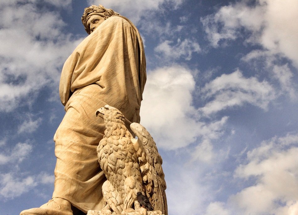 sculpture of Dante Alighieri under the sky with white clouds