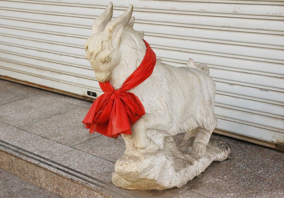 Beautiful Goat Sculpture with the red ribbon