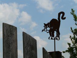 Kitty figure on a Wooden Garden fence