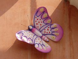 pink butterfly on brown surface