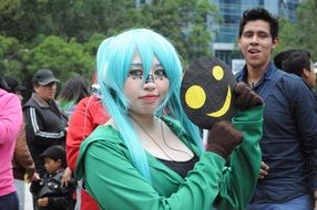 young lady in cosplay costume and blue wig