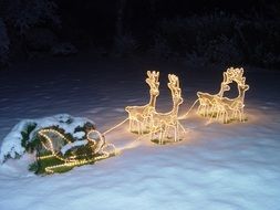 lighting Christmas decoration in snow