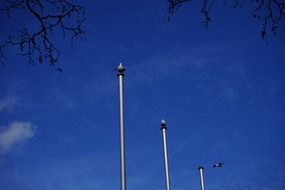flagpoles against the sky