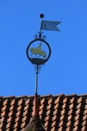 image of a horse on a rooftop weather vane