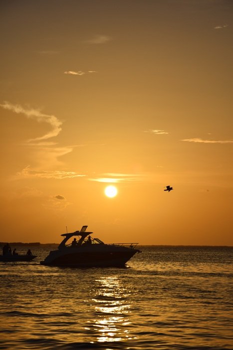 Boat on the water on the sunset background