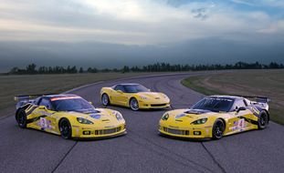 three yellow sports cars on the track
