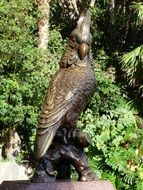 bronze sculpture of a parrot in park