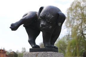 bronze dog sculpture close-up on blurred background