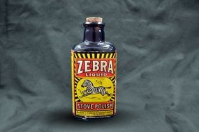 black glass bottle with a label