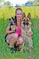girl with york and german shepherd on a green meadow