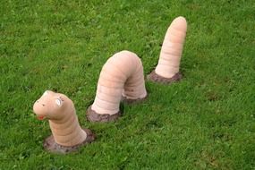 sculpture in the form of an earthworm on the green grass