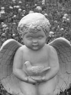 black and white photo of a stone angel statue