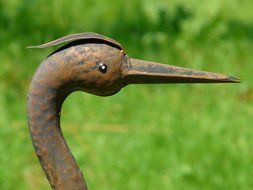 Heron Head statue close-up on blurred background