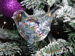 glass toy in the form of a bird at the Christmas tree