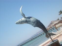 statue of a whale on the coast of mexico