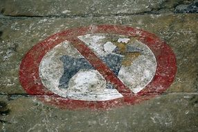 a sign forbidding passage with a dog