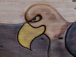 A wooden image of cartoon eagle drawing