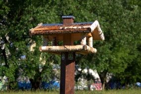 feeder in the form of a wooden house for the birds