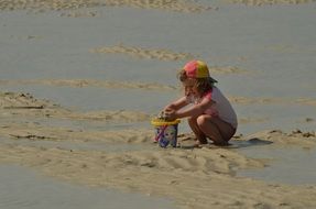 Girl with Bucket playing in Sand