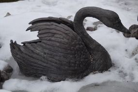 Swan, metal sculpture on Snow