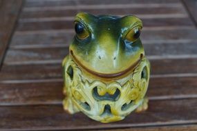 ceramic frog figurine close-up on blurred background