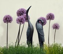 bird statues on a wild field