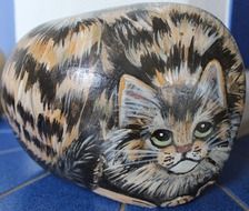 large stone with the image of a tabby cat