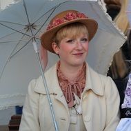 portrait of woman in a hat with an umbrella