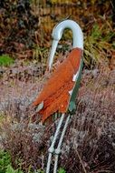 iron figure of a stork in the garden