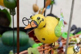 yellow bird in glasses as a decor for the garden