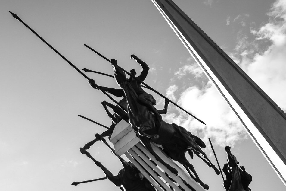 horsemen with spears Â at sky, bottom view of monument