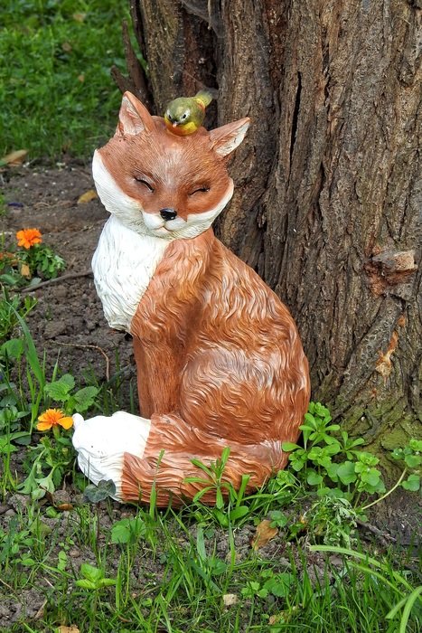 Bird Bath fox figure near tree