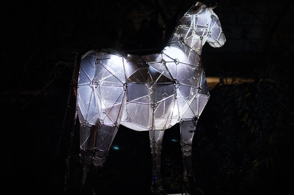 illuminated horse figure at night