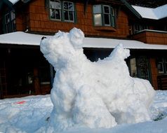 Beautiful and cute dog made of the snow
