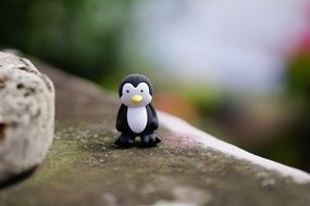 toy in the form of a penguin on a rock