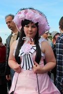 young woman in the pink cosplay costume