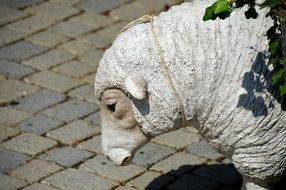 statue of a gypsum sheep in the street