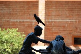 Picture of Crow is sitting on a statue