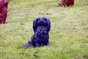 purple dog figurine in a dog park