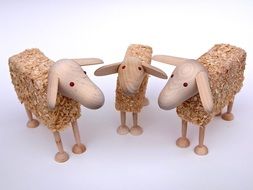 three toy wooden sheep