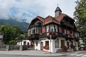 wooden house with balconies against the backdrop of the picturesque mountains, austria, Tyrol